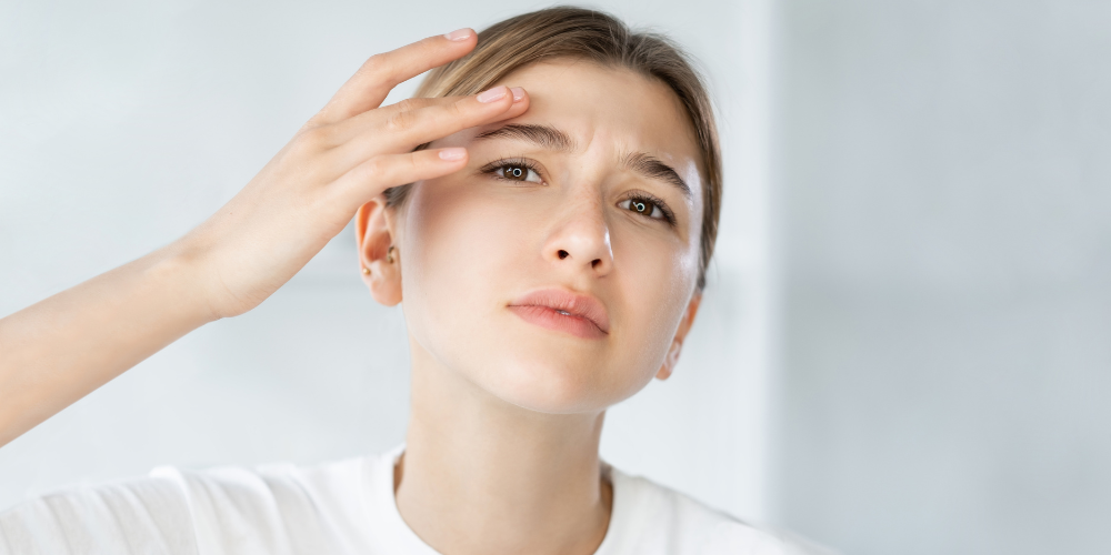 Image of teenager looking at their skin