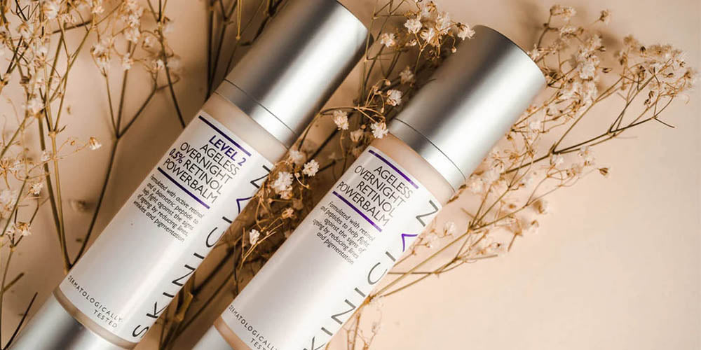 image of SKINICIAN Overnight Retinol Powerbalm Level 1 and Level 2 lying on flowers