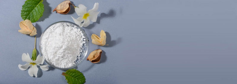 image of white powder in bowl surrounded by flowers