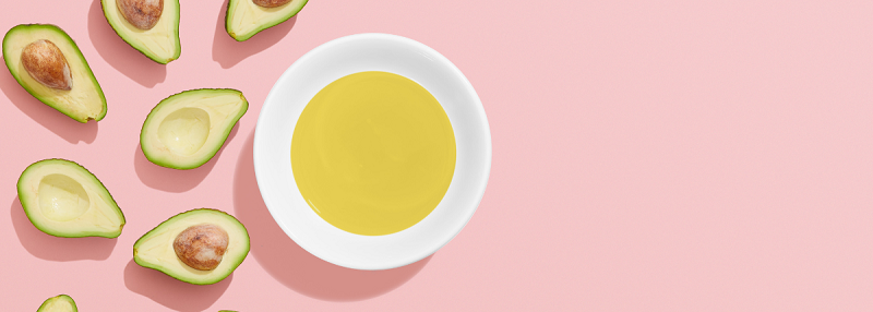 image of sliced avocados and bowl of avocado oil