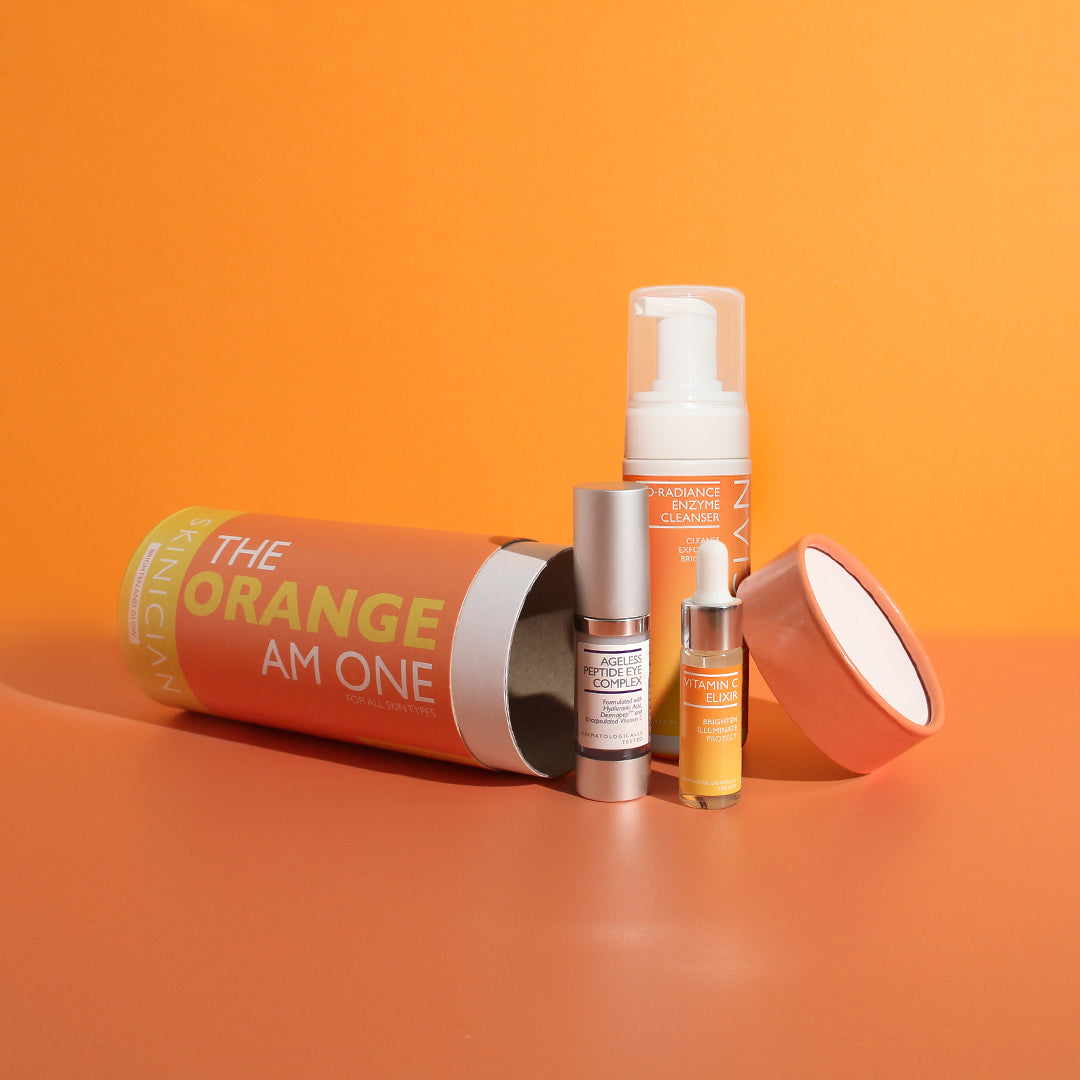 Image of The Orange One Set laying on its side with the products spilling out on orange background