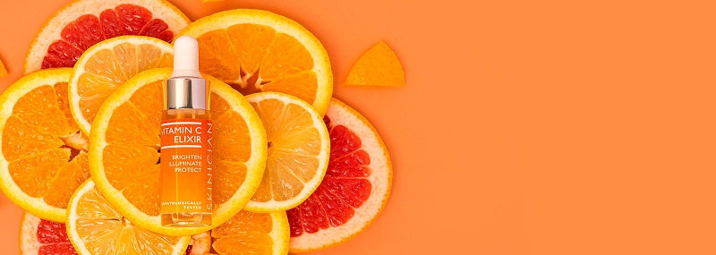 image of SKINICIAN Vitamin C Elixir laying on orange slices