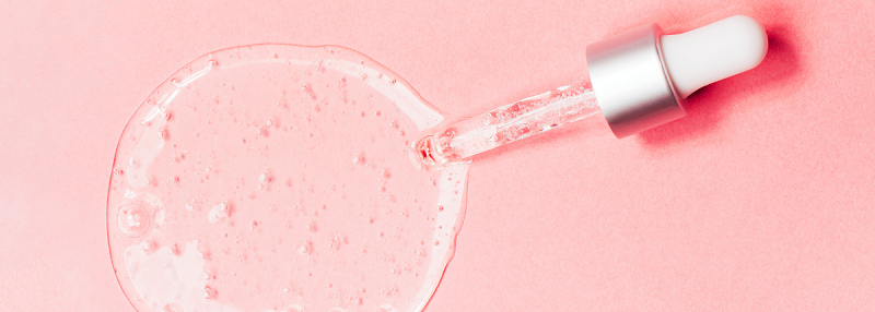 image of pipette dropping hyaluronic acid onto a pink background